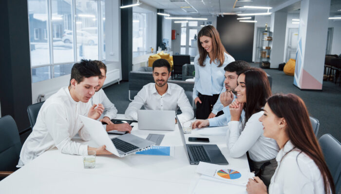showing-good-results-group-young-freelancers-office-have-conversation-smiling